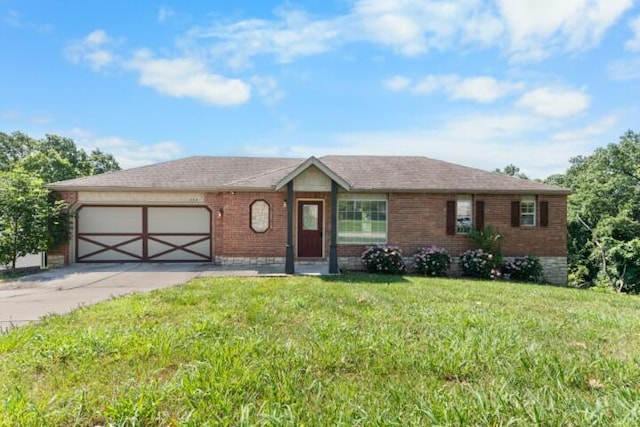 223 Roundhill Rd, Branson, MO 65616 - view of front facade featuring concrete driveway, a garage, brick siding, and a front yard