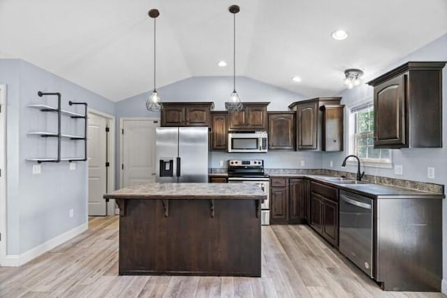 223 Roundhill Rd, Branson, MO 65616 - kitchen with stainless steel appliances, dark brown cabinetry, lofted ceiling, a center island, and decorative light fixtures