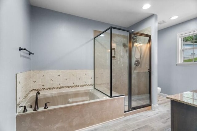 223 Roundhill Rd, Branson, MO 65616 - bathroom featuring vanity, a garden tub, a stall shower, wood finished floors, and recessed lighting