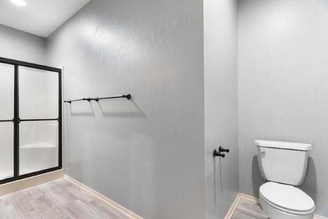 223 Roundhill Rd, Branson, MO 65616 - full bathroom featuring a stall shower and wood finished floors