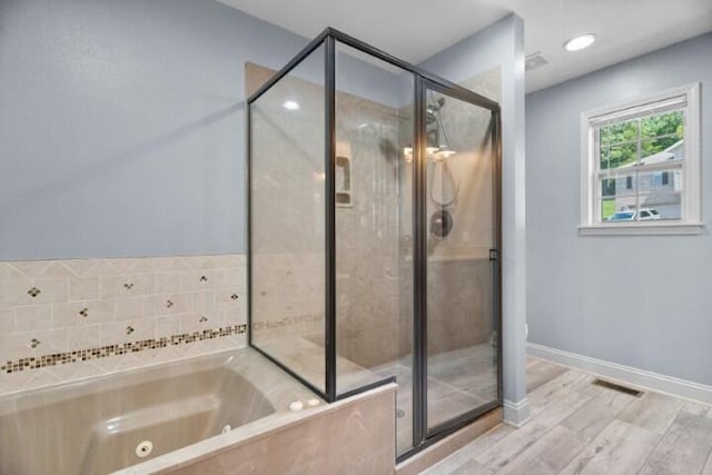 223 Roundhill Rd, Branson, MO 65616 - full bath with a tub with jets, a shower stall, and wood finished floors