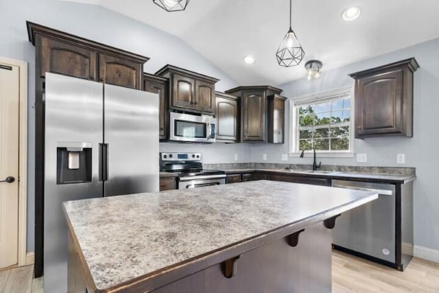 223 Roundhill Rd, Branson, MO 65616 - kitchen with appliances with stainless steel finishes, dark brown cabinets, lofted ceiling, light wood finished floors, and a kitchen island