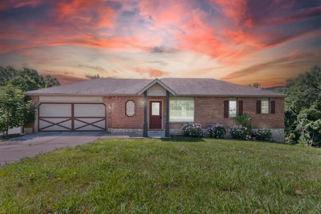 223 Roundhill Rd, Branson, MO 65616 - view of front of house with brick siding, a garage, driveway, and a yard