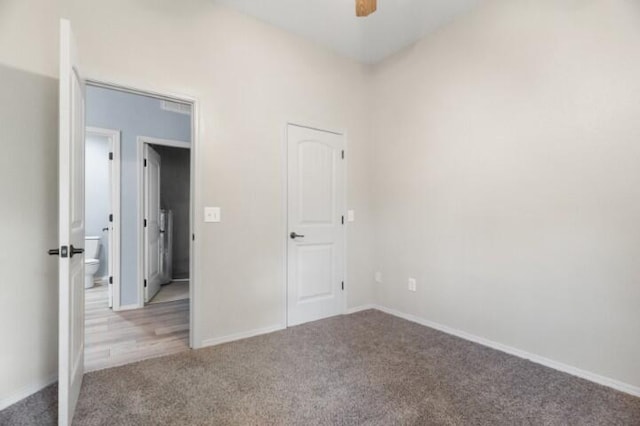223 Roundhill Rd, Branson, MO 65616 - unfurnished bedroom with carpet floors, ensuite bathroom, and a ceiling fan