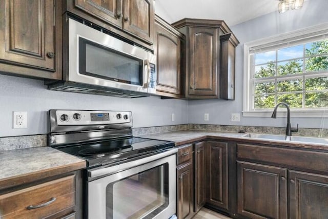 223 Roundhill Rd, Branson, MO 65616 - kitchen with stainless steel appliances and dark brown cabinets