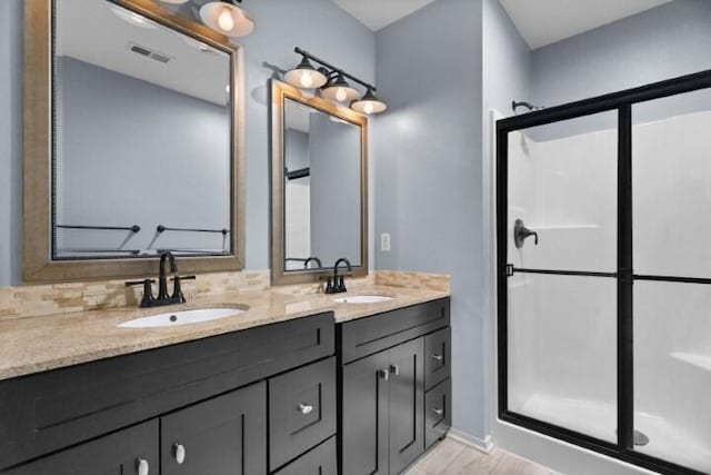 223 Roundhill Rd, Branson, MO 65616 - full bath featuring double vanity, a shower stall, and wood finished floors
