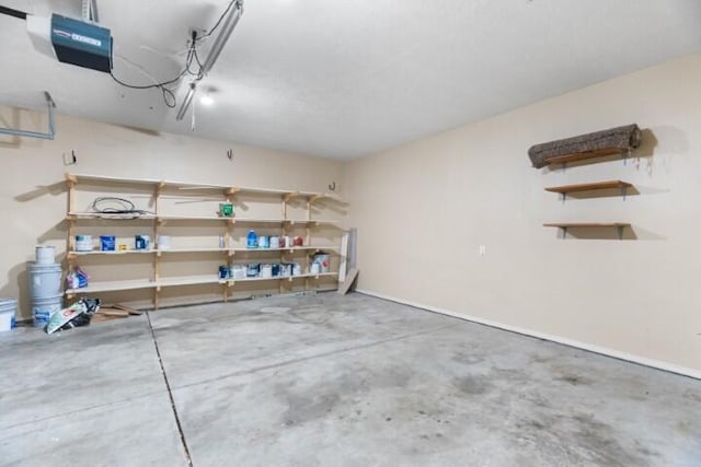 223 Roundhill Rd, Branson, MO 65616 - garage with a garage door opener and baseboards