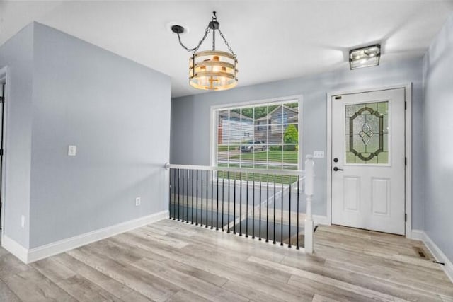 223 Roundhill Rd, Branson, MO 65616 - entrance foyer featuring wood finished floors and a chandelier