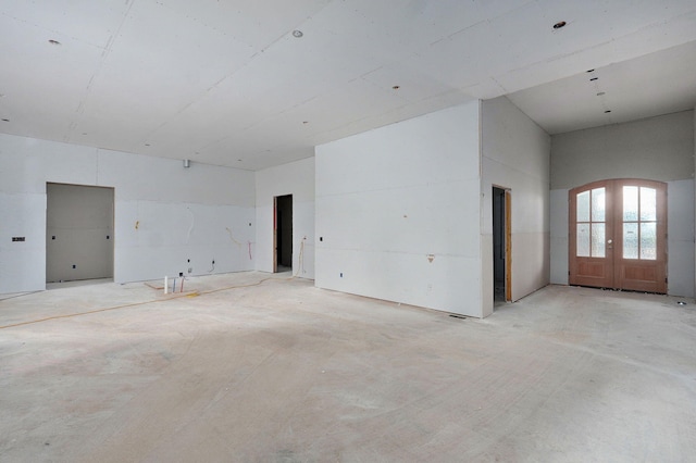 LOT20 N Silver Charm Ave, Springfield, MO 65802 - spare room featuring french doors, unfinished concrete flooring, and arched walkways