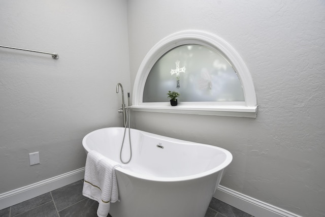 3457 S Barnes Ave, Springfield, MO 65804 - bathroom with tile patterned floors and a freestanding bath