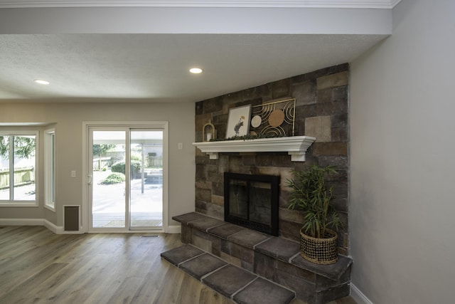 3457 S Barnes Ave, Springfield, MO 65804 - living room with wood finished floors, recessed lighting, and a stone fireplace