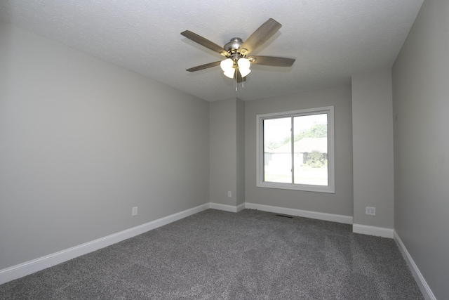 3457 S Barnes Ave, Springfield, MO 65804 - spare room featuring dark colored carpet, a textured ceiling, and ceiling fan