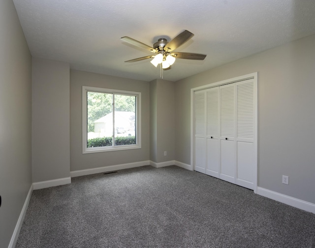 3457 S Barnes Ave, Springfield, MO 65804 - unfurnished bedroom with dark colored carpet, a closet, and a ceiling fan