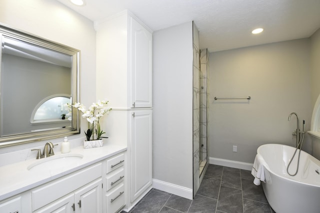 3457 S Barnes Ave, Springfield, MO 65804 - full bath with vanity, a freestanding tub, a shower stall, recessed lighting, and tile patterned floors