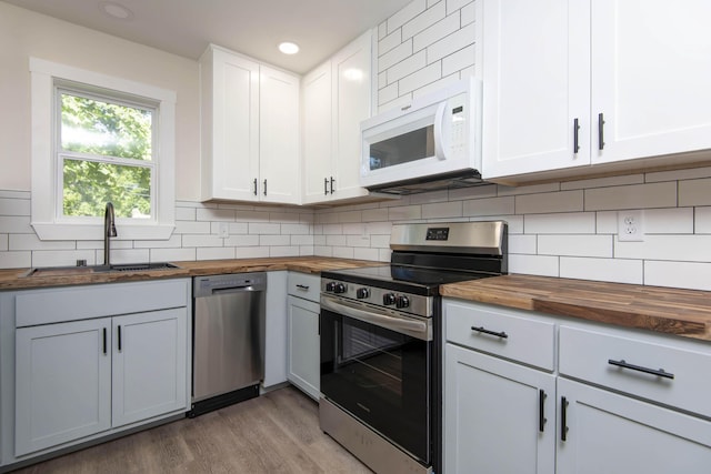 1830 N Hillcrest Ave, Springfield, MO 65802 - kitchen featuring wooden counters, stainless steel appliances, light wood-style flooring, backsplash, and recessed lighting