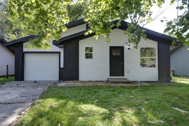 1830 N Hillcrest Ave, Springfield, MO 65802 - view of front facade with a garage, concrete driveway, a front lawn, and brick siding
