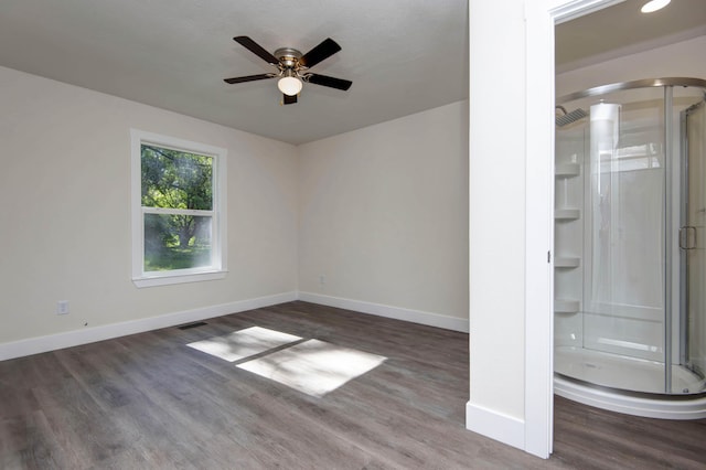 1830 N Hillcrest Ave, Springfield, MO 65802 - spare room featuring arched walkways, wood finished floors, and ceiling fan