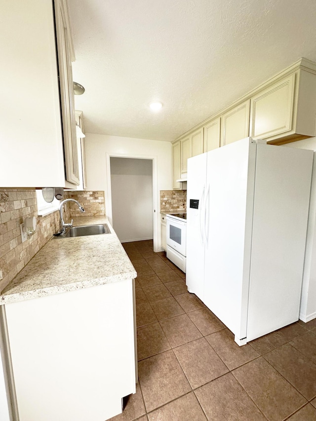 751 Logan St, Rogersville, MO 65742 - kitchen with white appliances, backsplash, light countertops, tile patterned flooring, and cream cabinetry