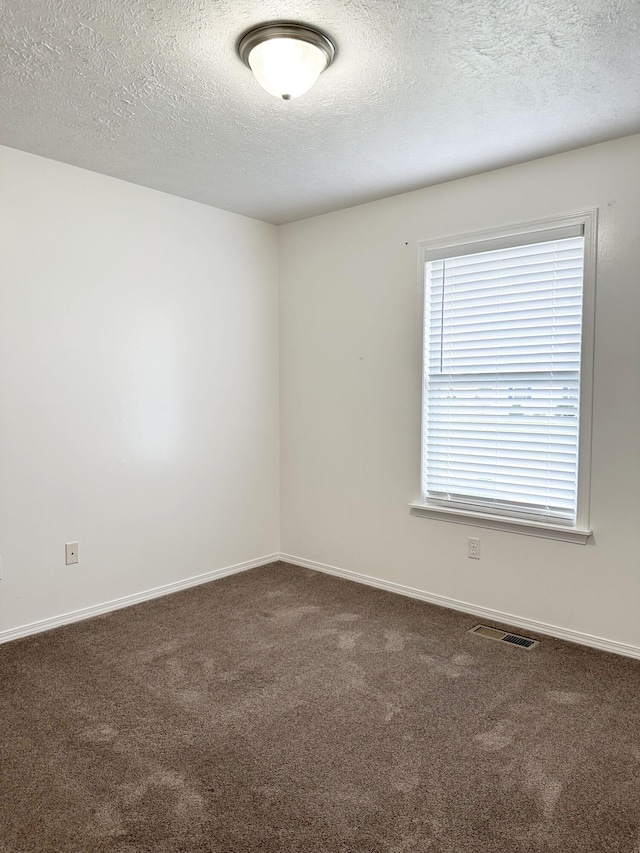 751 Logan St, Rogersville, MO 65742 - spare room featuring dark carpet and a textured ceiling
