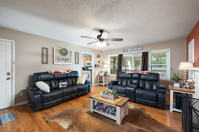 1704 E Latoka St, Springfield, MO 65804 - living area with a ceiling fan, wood finished floors, and a textured ceiling