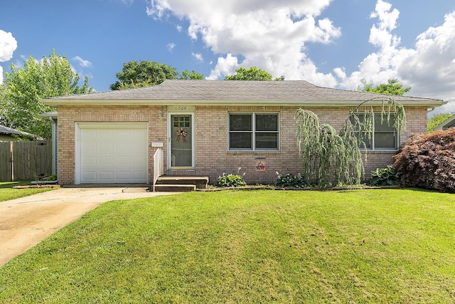 1704 E Latoka St, Springfield, MO 65804 - ranch-style house with brick siding, an attached garage, and driveway