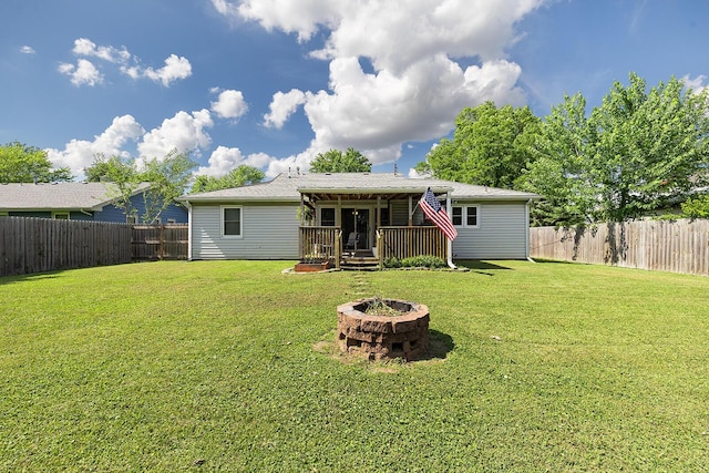 1704 E Latoka St, Springfield, MO 65804 - rear view of house featuring an outdoor fire pit, a wooden deck, and a fenced backyard