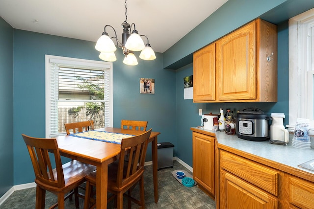 1704 E Latoka St, Springfield, MO 65804 - dining space featuring a chandelier and baseboards