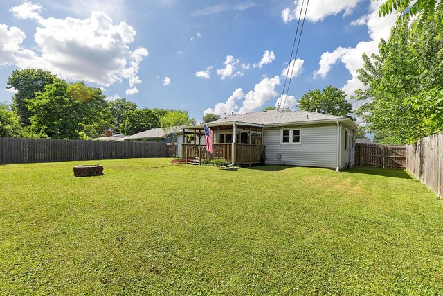 1704 E Latoka St, Springfield, MO 65804 - fenced backyard with an outdoor fire pit and a wooden deck
