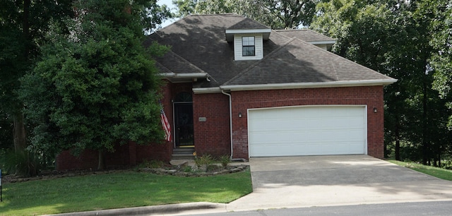 1350 Pointe Royale Dr, Branson, MO 65616 - view of front of property featuring a shingled roof, a garage, driveway, a front yard, and brick siding