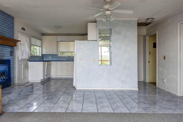 730 Peebles Point Rd, Cape Fair, MO 65624 - kitchen featuring dark countertops, light tile patterned floors, a ceiling fan, ornamental molding, and a fireplace
