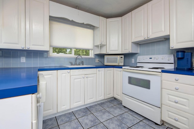 730 Peebles Point Rd, Cape Fair, MO 65624 - kitchen with white appliances, decorative backsplash, white cabinets, and light tile patterned floors