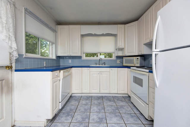 730 Peebles Point Rd, Cape Fair, MO 65624 - kitchen featuring white appliances, light tile patterned floors, white cabinets, and backsplash