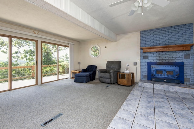 730 Peebles Point Rd, Cape Fair, MO 65624 - carpeted living area featuring a fireplace, ceiling fan, and tile patterned flooring