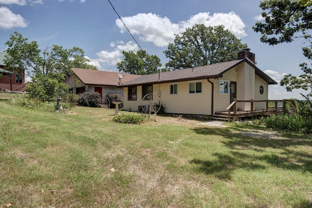 730 Peebles Point Rd, Cape Fair, MO 65624 - rear view of house with a chimney, a yard, and a wooden deck
