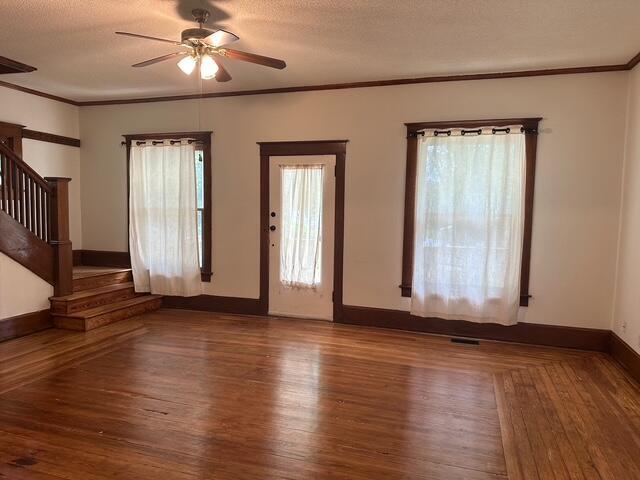 514 N Joplin Ave, Joplin, MO 64801 - entrance foyer with stairway, a ceiling fan, wood finished floors, crown molding, and a textured ceiling