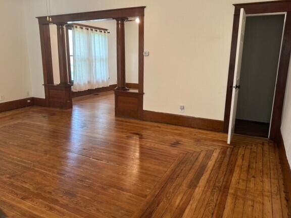514 N Joplin Ave, Joplin, MO 64801 - unfurnished room featuring ornate columns and wood finished floors