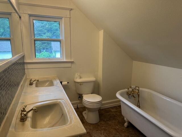 514 N Joplin Ave, Joplin, MO 64801 - full bathroom with vaulted ceiling, a freestanding bath, and double vanity