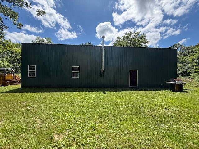890 Bluebird Ln, Sparta, MO 65753 - view of side of home featuring a lawn, a pole building, and an outbuilding