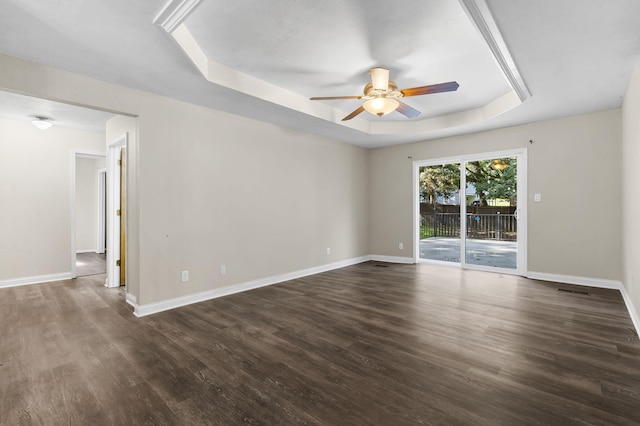 167 Eagle Valley Ct, Hollister, MO 65672 - empty room featuring a raised ceiling, a ceiling fan, and dark wood finished floors