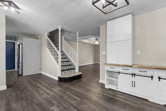 167 Eagle Valley Ct, Hollister, MO 65672 - basement featuring stairs, dark wood-style flooring, freestanding refrigerator, and ceiling fan