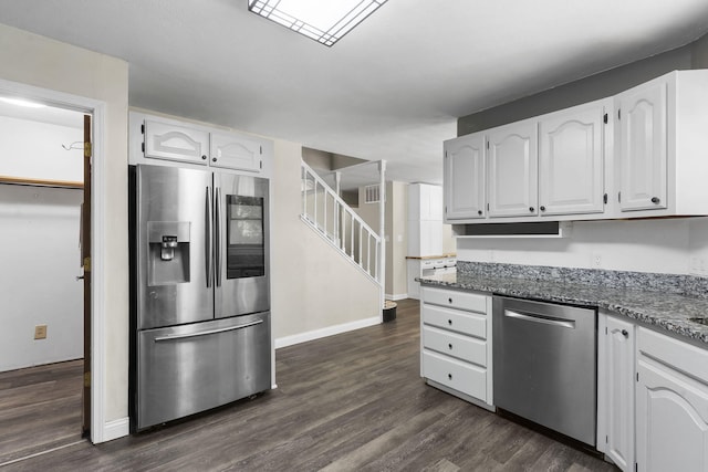 167 Eagle Valley Ct, Hollister, MO 65672 - kitchen featuring appliances with stainless steel finishes, white cabinets, dark wood finished floors, and stone countertops