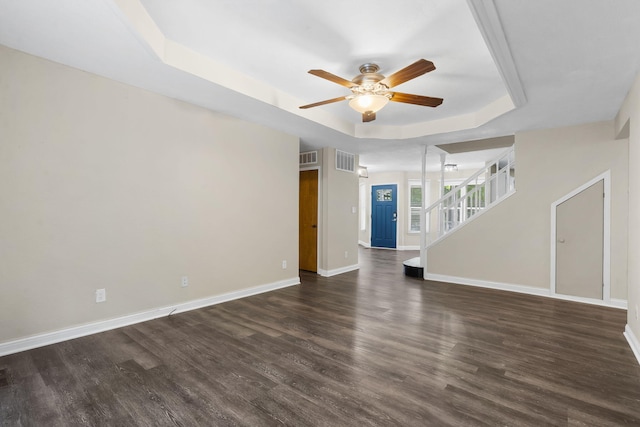 167 Eagle Valley Ct, Hollister, MO 65672 - unfurnished living room with a tray ceiling, a ceiling fan, dark wood finished floors, and stairway