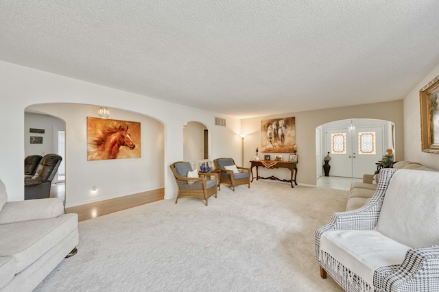 29 Trail Ridge Dr, Kimberling City, MO 65686 - living room with arched walkways, light colored carpet, and a textured ceiling