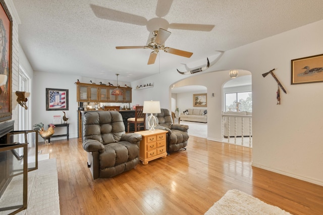 29 Trail Ridge Dr, Kimberling City, MO 65686 - living room with arched walkways, ceiling fan, a textured ceiling, and light wood-type flooring