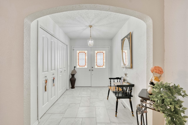 29 Trail Ridge Dr, Kimberling City, MO 65686 - entryway with a chandelier, light marble finish flooring, and a textured ceiling