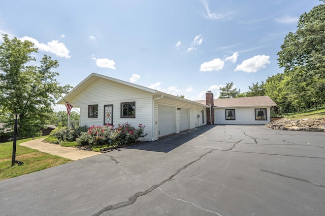29 Trail Ridge Dr, Kimberling City, MO 65686 - single story home featuring an attached garage, asphalt driveway, and a chimney