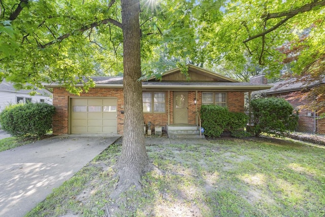 716 S Rogers Ave, Springfield, MO 65804 - view of front of home with a garage, concrete driveway, and brick siding