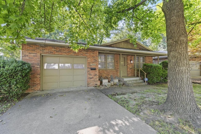 716 S Rogers Ave, Springfield, MO 65804 - view of front of home featuring a garage, brick siding, and concrete driveway