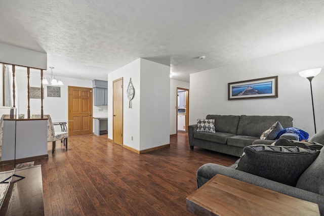 716 S Rogers Ave, Springfield, MO 65804 - living area featuring dark wood-style floors, a chandelier, and a textured ceiling