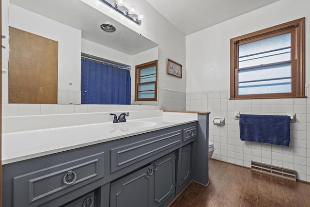 716 S Rogers Ave, Springfield, MO 65804 - full bath featuring tile walls, vanity, wood finished floors, and wainscoting